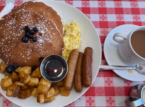 Fluffy pancakes with blueberries, eggs and sausage